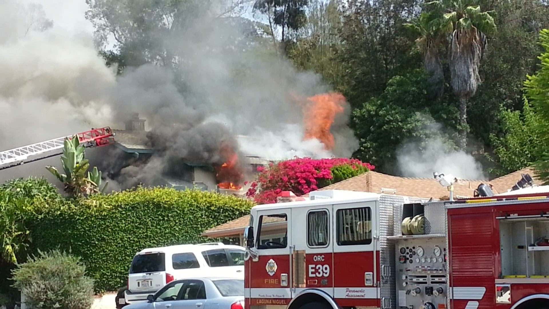 Fire crews and an engine at a burning single-family home, the kind of total-loss fire claim Accurate Claims Consulting helps Spokane, WA property owners document and negotiate